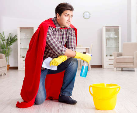 Super hero husband cleaning floor at homeの写真素材