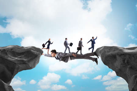 Businessman acting as a bridge in support conceptの写真素材