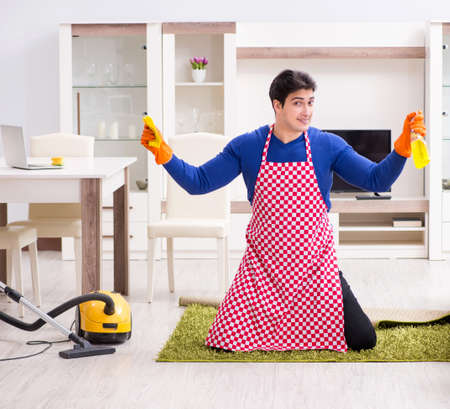 Contractor man cleaning house doing choresの写真素材