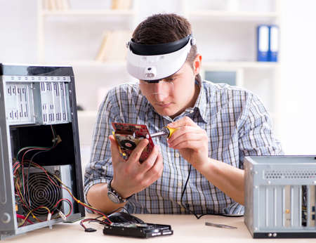 The young technician repairing computer in workshop