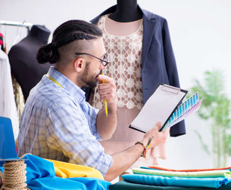 Male tailor working in the workshop on new designs