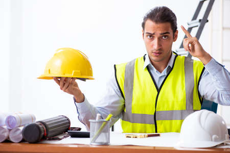 Young male architect working indoors