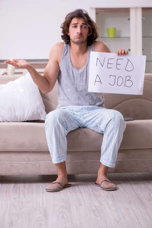 Unemployed man desperate at homeの写真素材