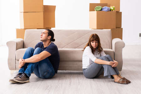Young pair and many boxes in divorce settlement concept