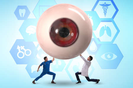 Doctor examining giant eye in medical conceptの写真素材