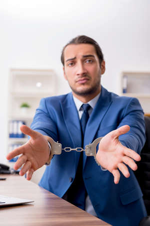 Young male businessman employee working in the officeの写真素材