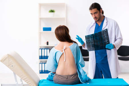 Injured young woman visiting young male doctor