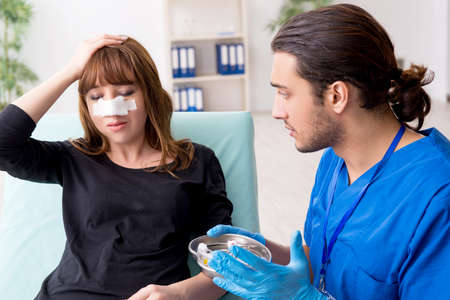 Young beautiful woman visiting doctor in plastic surgery concept
