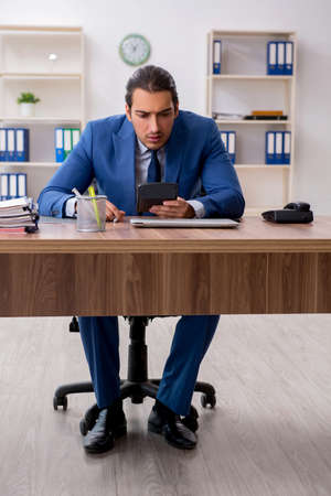 Young male businessman employee working in the officeの写真素材