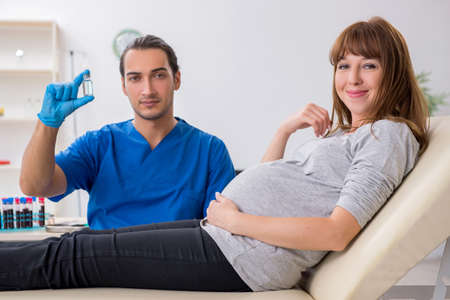 Young pregnant woman in blood transfusion conceptの写真素材