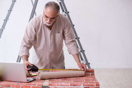 Old husband contractor in home renovation conceptの写真素材