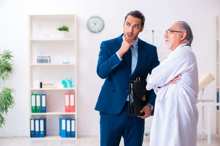 Male doctor and businessman discussing medical projectの写真素材