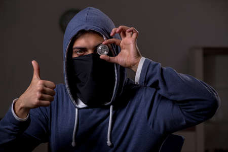 Male hacker hacking security firewall late in officeの写真素材