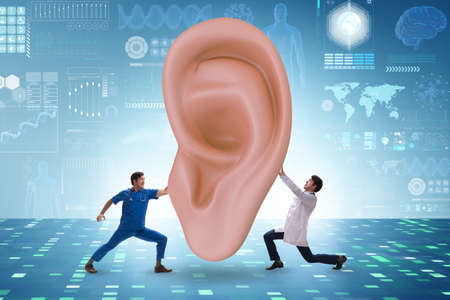 Doctor examining giant ear in medical conceptの写真素材