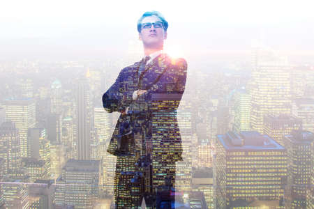Successful businessman against cityscape in business conceptの写真素材