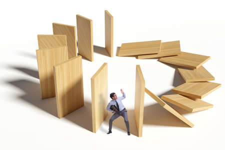 Businessman in domino effect concept