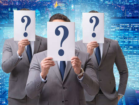 Businessman in uncertainty concept with question marks