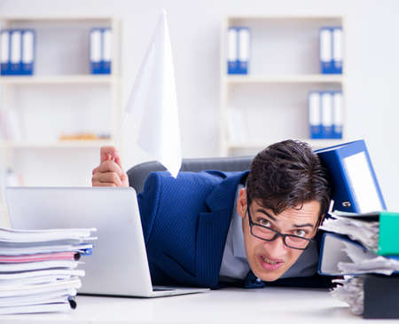 Businessman throwing white flag and giving upの写真素材