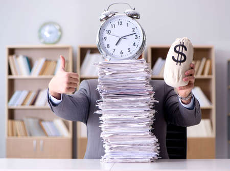 Businessman struggling to meet challenging deadlinesの写真素材