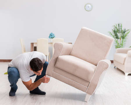 Man moving furniture at homeの写真素材
