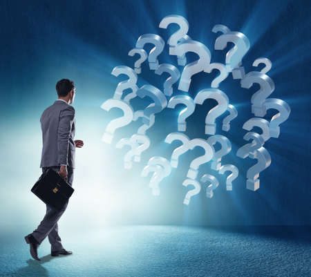 The businessman in uncertainty concept with question marksの写真素材