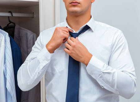 Businessman dressing up for work