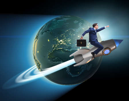 The businessman on the rocket in global business conceptの写真素材