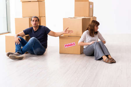 Young pair and many boxes in divorce settlement concept