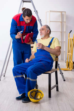 Two contractors in first aid conceptの写真素材