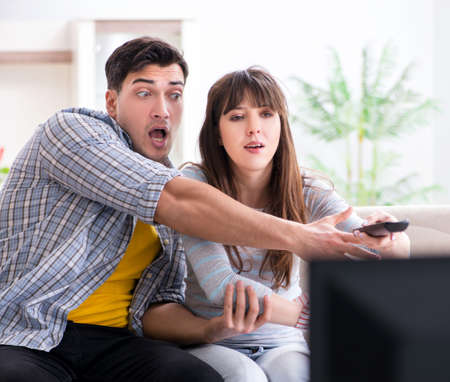 Pair watching tv at home