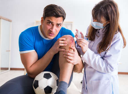 Football soccer player visiting doctor after injuryの写真素材