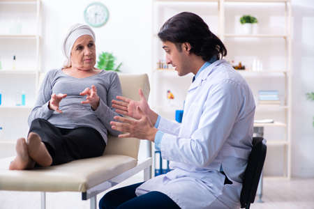 Young male doctor and female oncology patientの写真素材