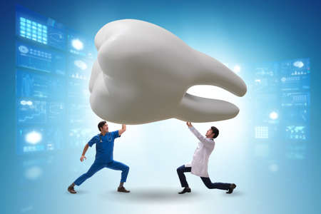 Doctors examining giant tooth in dental conceptの写真素材