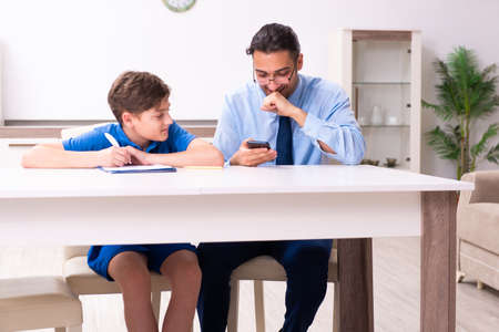 Busy father helping his son to prepare for examの写真素材