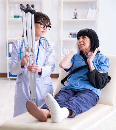 Doctor examining old mature woman after incidentの写真素材