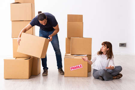 Young pair and many boxes in divorce settlement concept