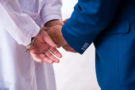Male doctor in courthouse meeting with lawyer