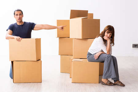 Young pair and many boxes in divorce settlement concept