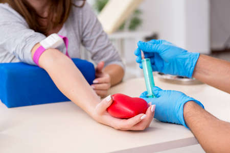 Young woman in the blood transfusion conceptの写真素材