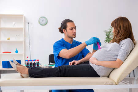 Young pregnant woman in blood transfusion conceptの写真素材