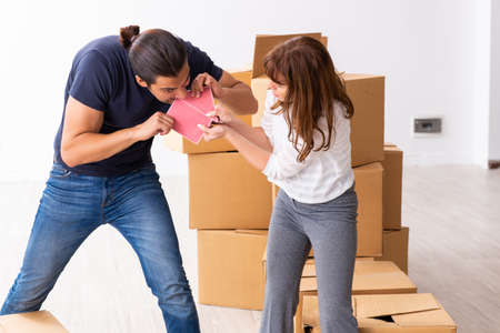 Young pair and many boxes in divorce settlement concept