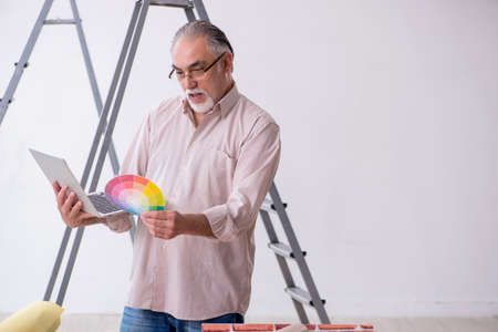 Old husband contractor in home renovation conceptの写真素材