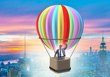 The businessman flying on balloon in challenge conceptの写真素材