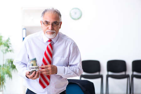 Old male accountant in budget planning conceptの写真素材