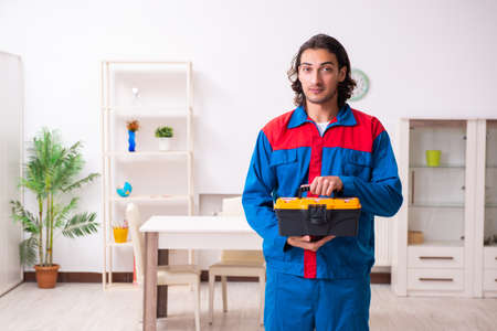 Young male carpenter working indoors