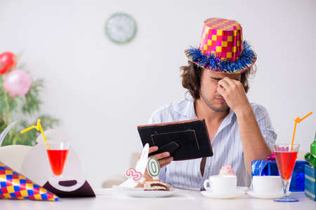 Young man celebrating his birthday at homeの写真素材