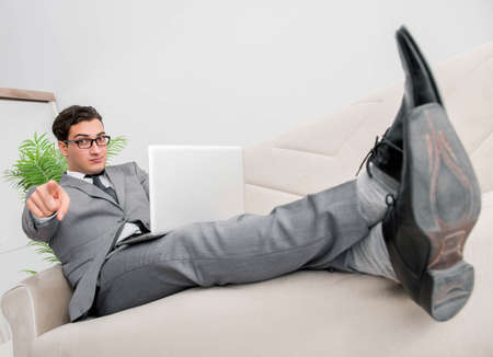 Young businessman lying on the sofa
