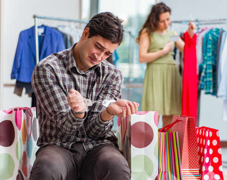 Man fed up with wife shopping in shopの写真素材