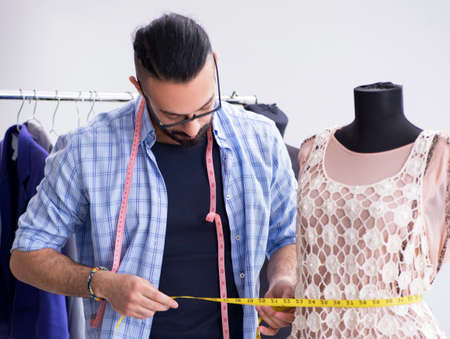Male tailor working in the workshop on new designsの写真素材