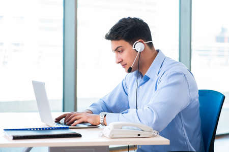 Male call-center operator in business conceptの写真素材